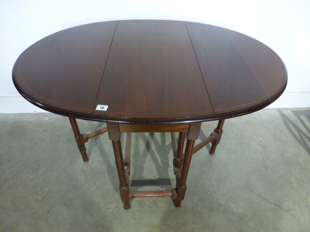 A mahogany and inlaid drop leaf table