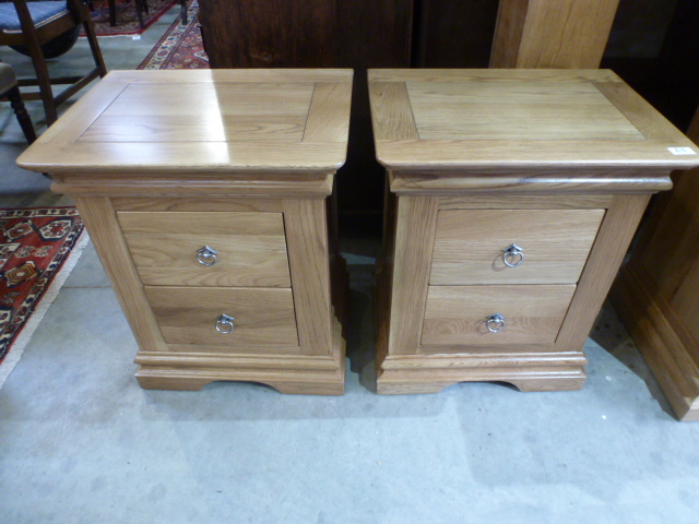 A pair of modern oak two drawer bedside chests