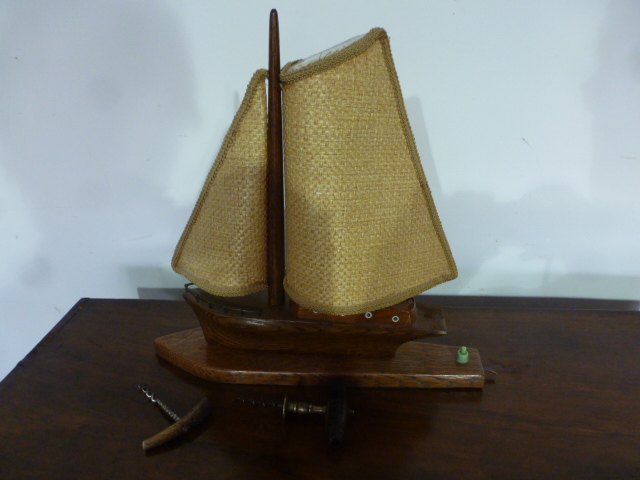 A circa 1940's oak table lamp in the form of a yacht along with a 19th century lignum vitae and