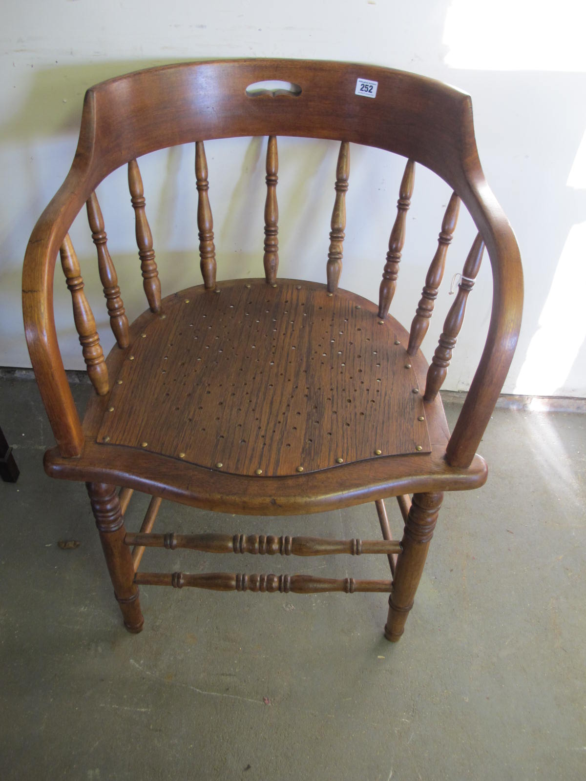 An early 20th century beechwood spindle back desk chair