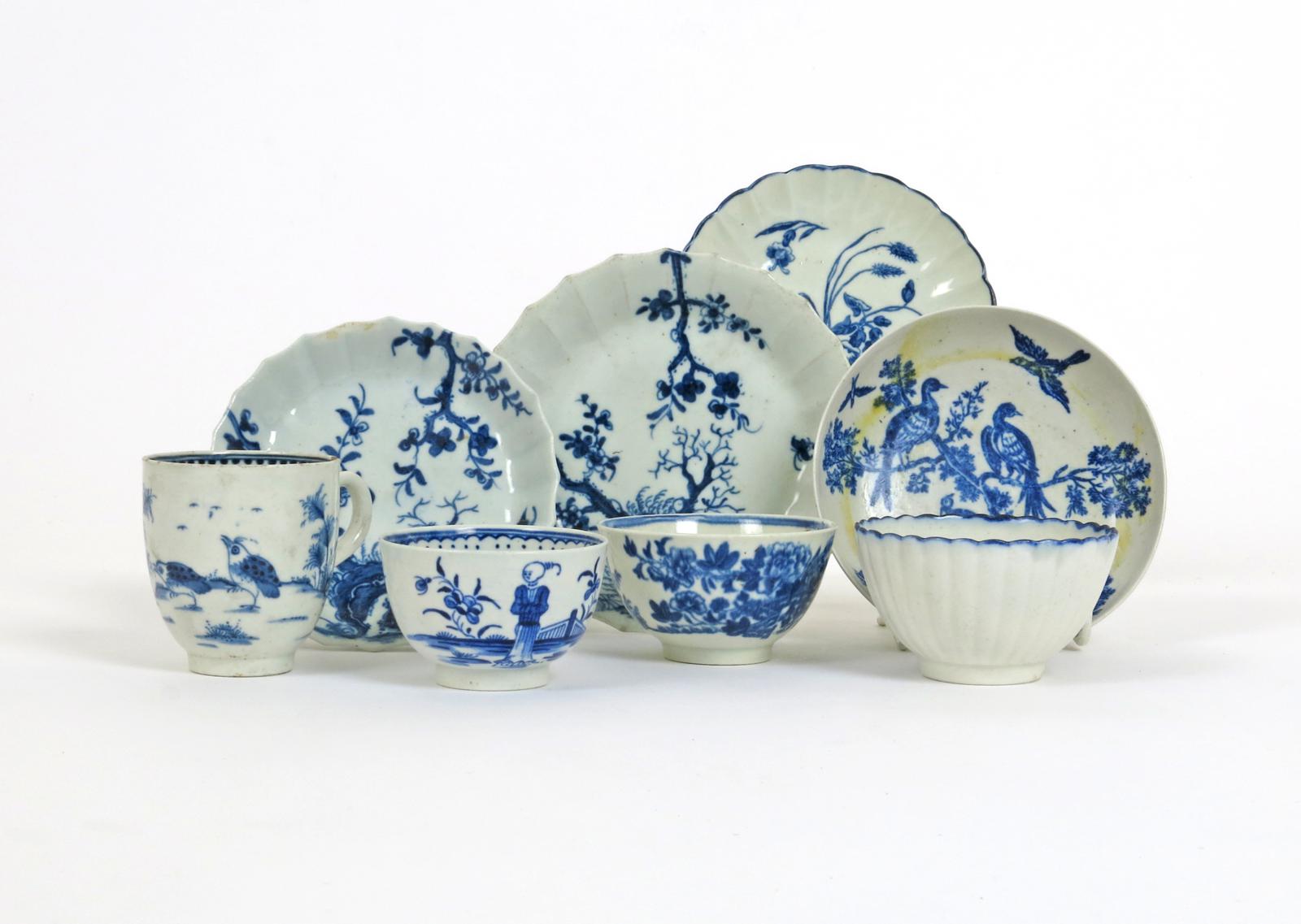 Four Worcester blue and white saucers  c.1755-75, two Warmstry-fluted and painted with the Prunus