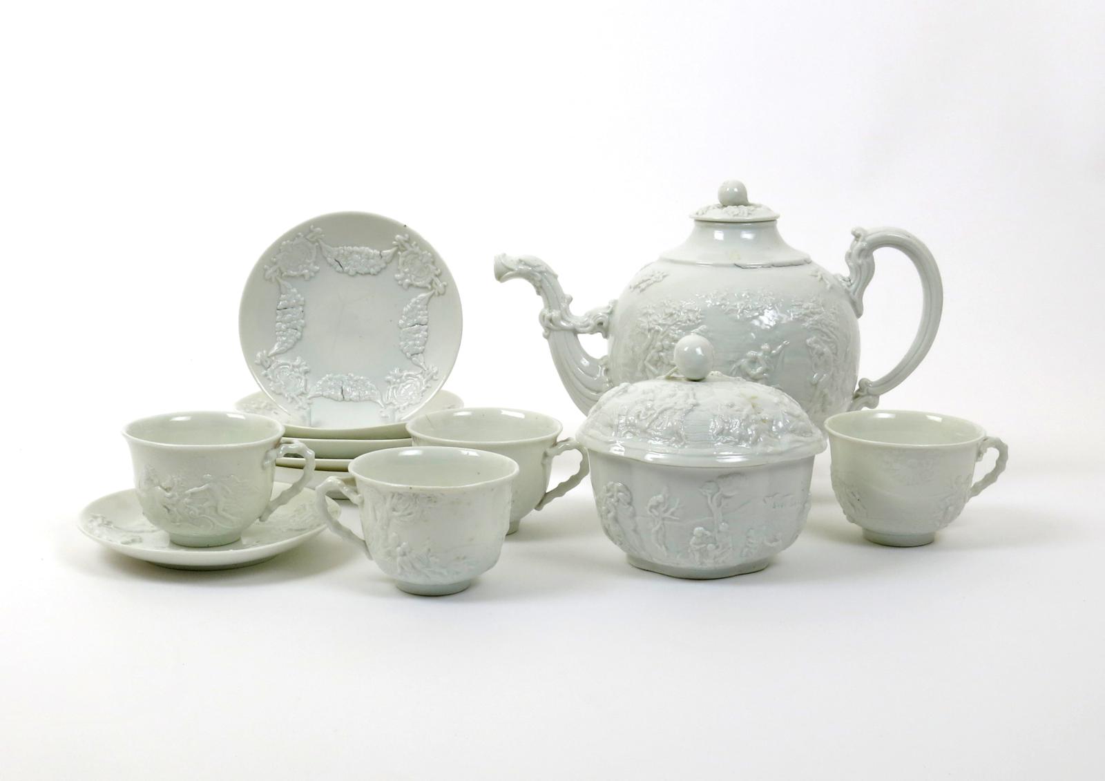 An Italian porcelain part tea service  19th century, moulded in the Doccia manner with scenes of