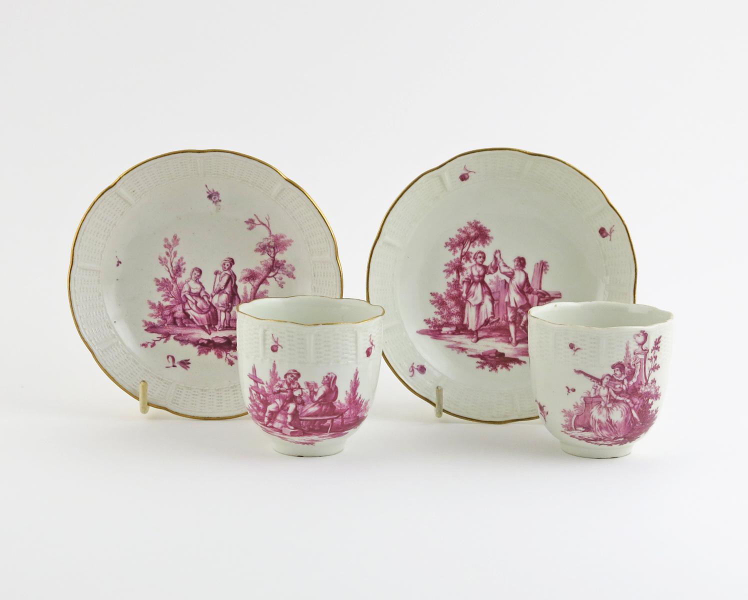 A pair of Ludwigsburg coffee cups and saucers  c.1775-80, painted in purpurmalerei with couples