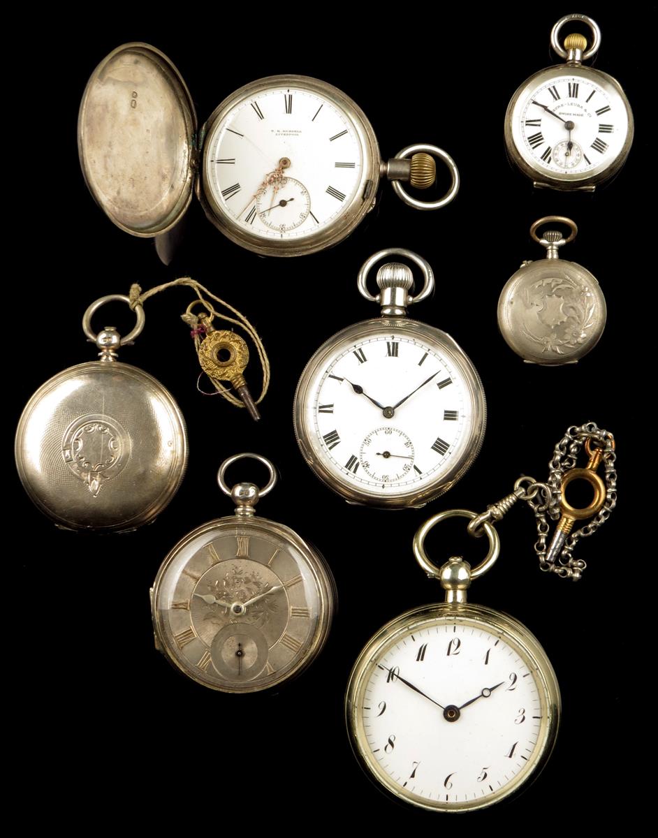 Two hunting cased lever watches; two open faced lever watches one having a silver dial; two lady`s
