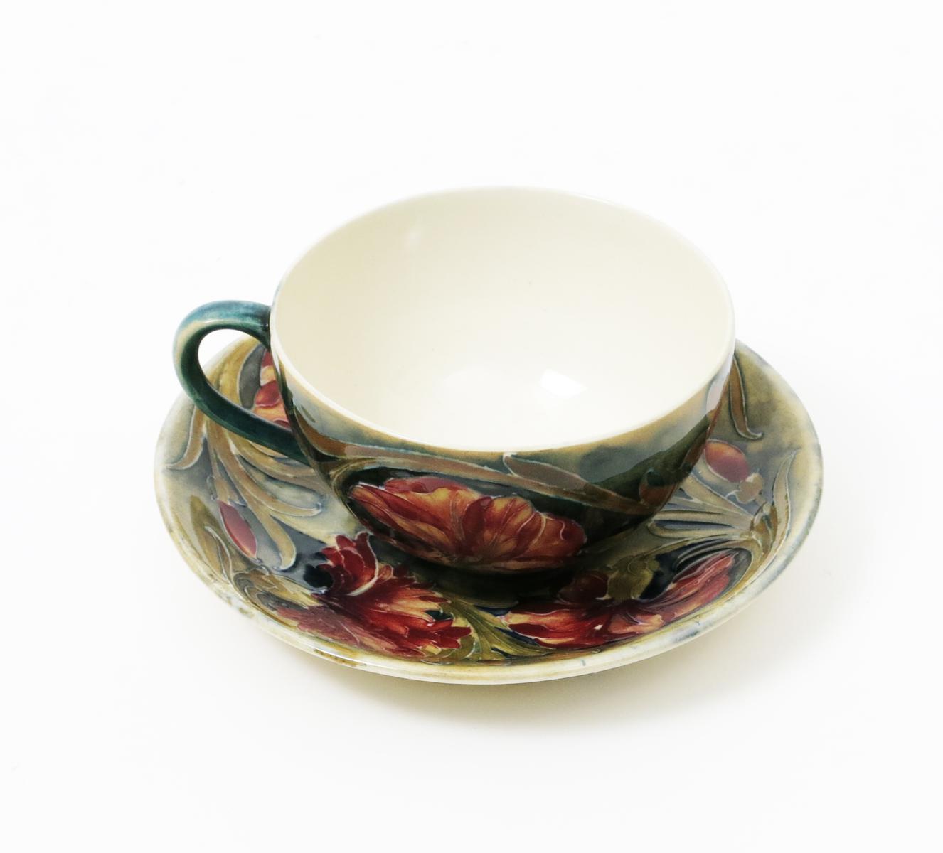 `Spanish` A Moorcroft cup and saucer designed by William Moorcroft, painted in shades of pink, - Image 2 of 2
