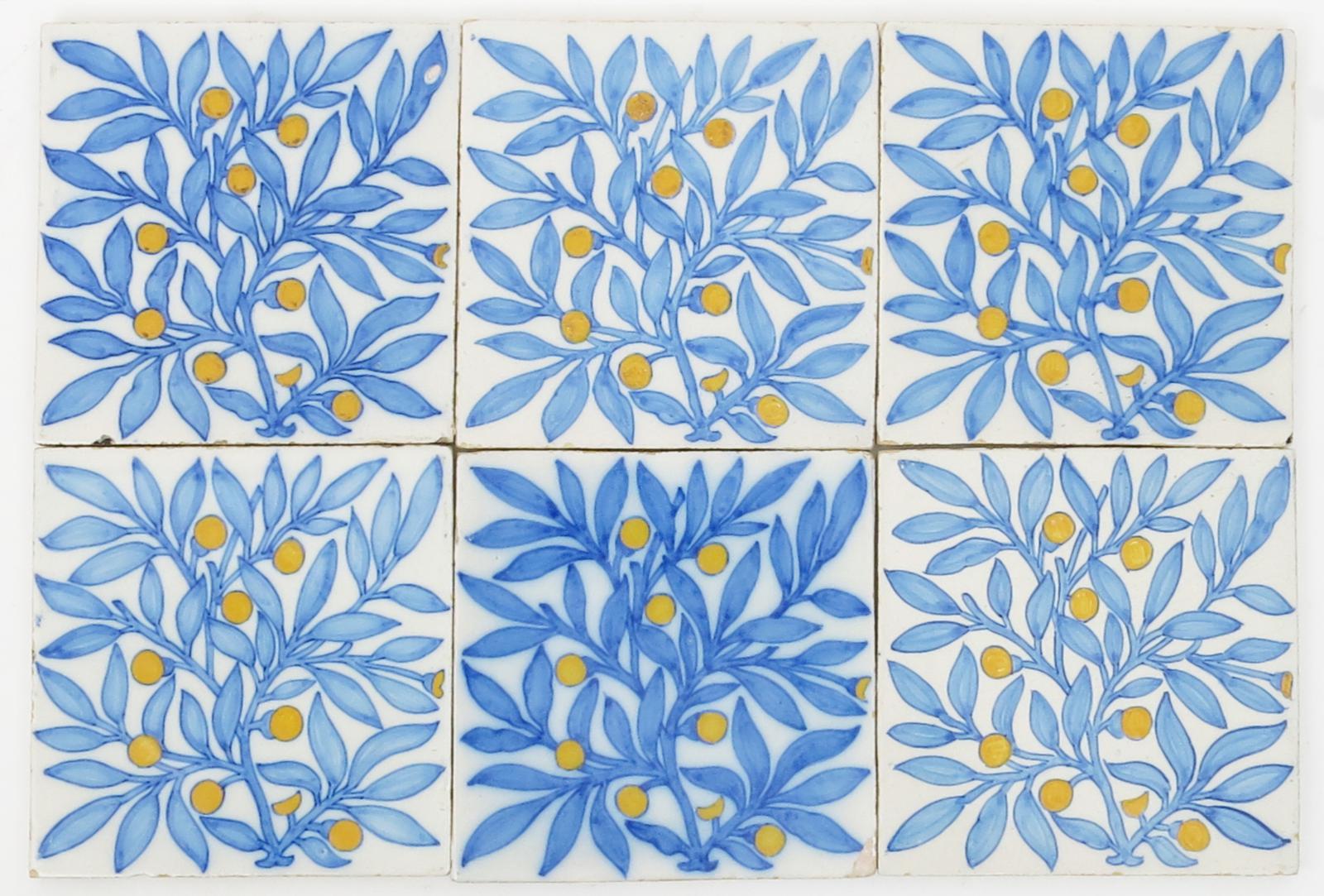 Eight tin-glaze tiles in the manner of Morris & Co, decorated with a bough of berried foliage in
