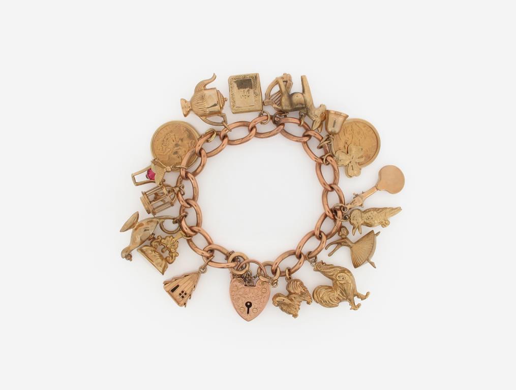 A gold charm bracelet, mounted with assorted charms and two half sovereigns. 62g.