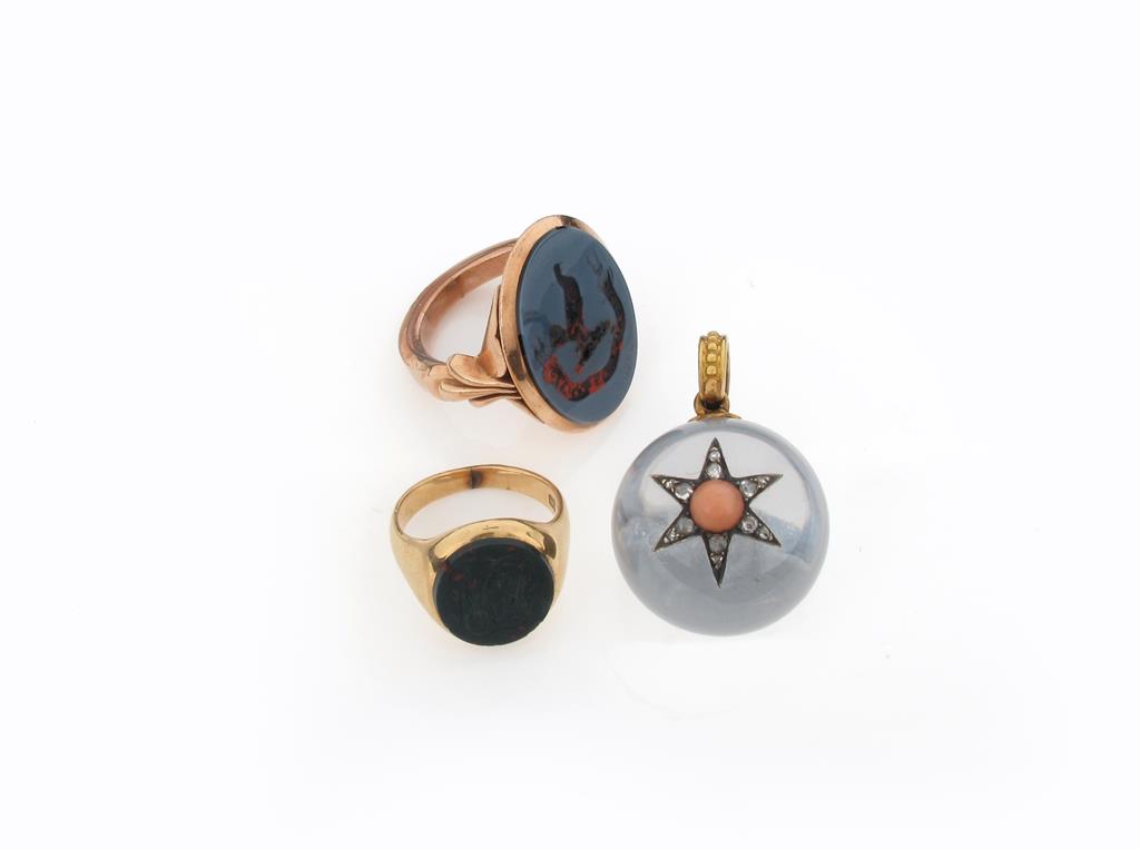 A spherical rock crystal pendant, surmounted with a coral and diamond set star, an agate mounted