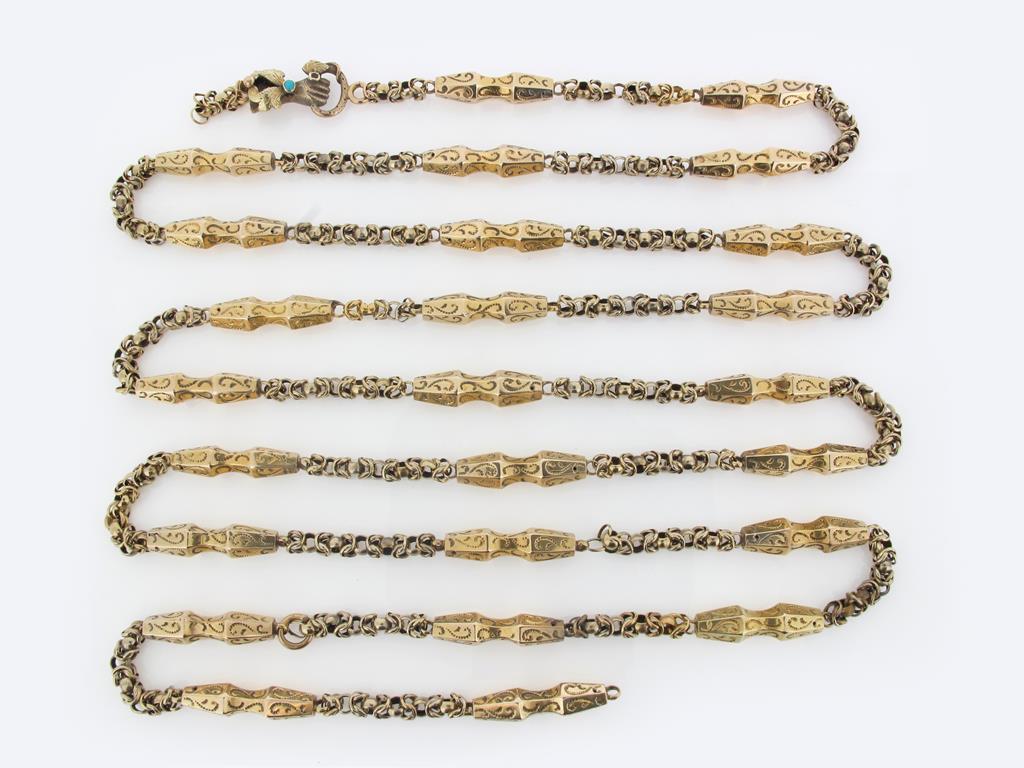 A 19th century gold long guard chain, the fancy links (broken) with a gold clasp depicting a hand