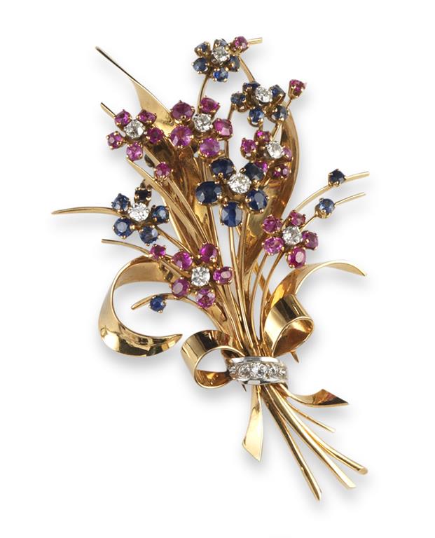 A gem-set stylised gold floral brooch, set with diamonds, rubies and sapphires, 8.5cm. 32g.