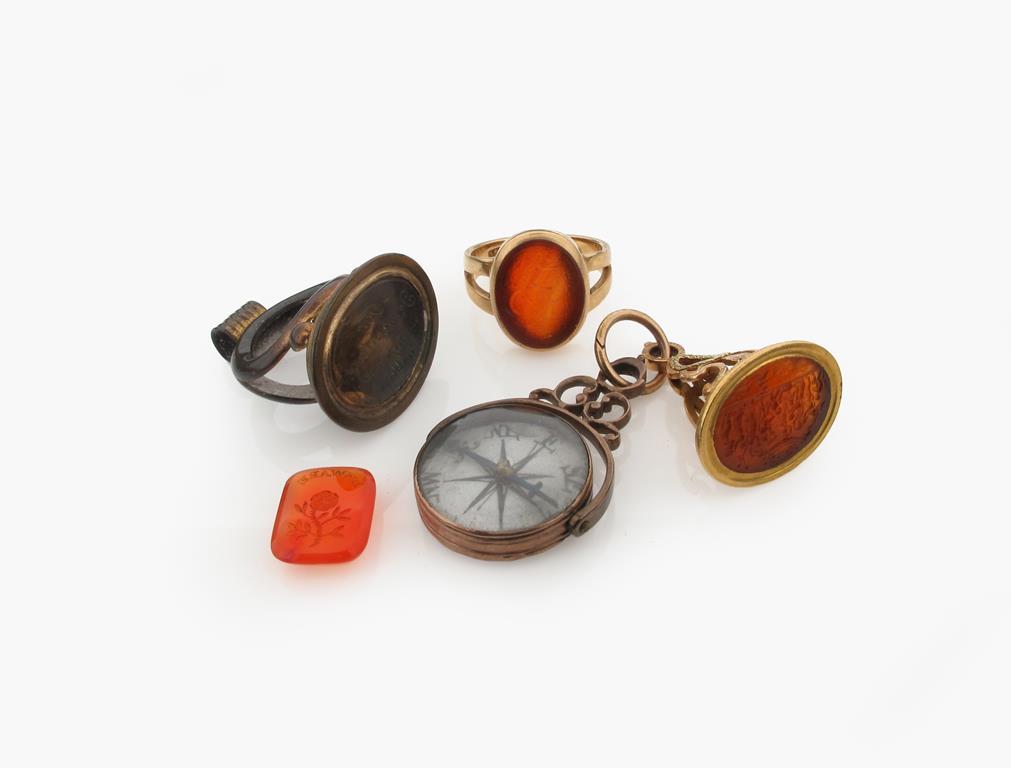 A George III two colour gold mounted carnelian intaglio fob seal, carved with a Bacchanalian