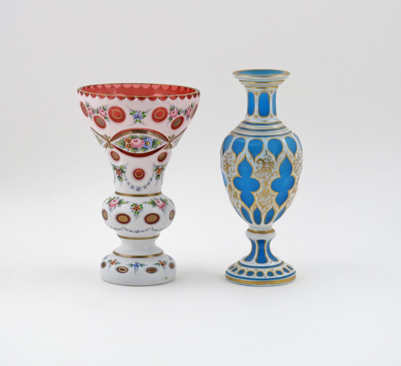 Two Bohemian glass vases, 19th century, one cranberry and overlaid in white, cut with a circular