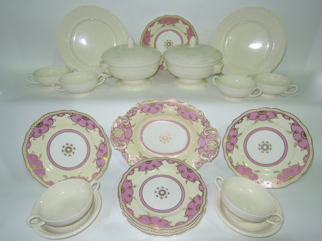 A collection of Wedgwood cream glazed dinner wares with classical style fluted moulding and rams