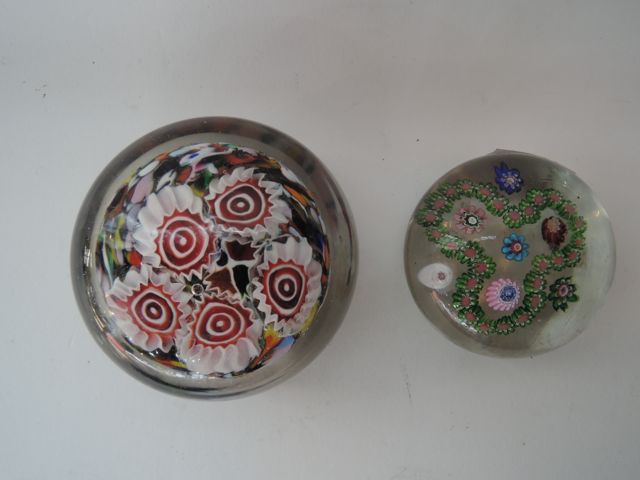 A small Millefiori glass paperweight with flowers in shades of red, blue, pink, green, etc encased