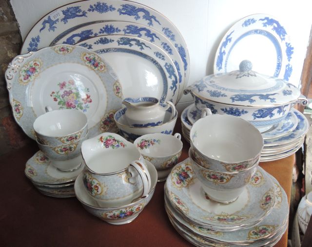 A collection of Cauldon blue and white printed Dragon pattern dinner wares comprising three oval