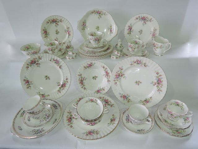 A quantity of Royal Albert Moss Rose pattern dinner and tea wares comprising four dinner plates,