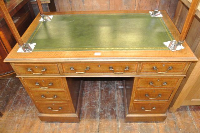 An inlaid Edwardian mahogany pedestal desk of nine drawers with inset leather top crossbanded in