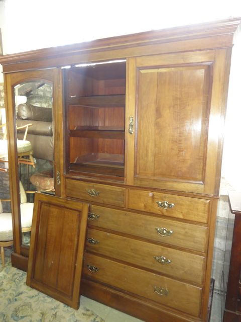 A good quality Edwardian walnut compactum wardrobe with stepped and moulded cornice over a full