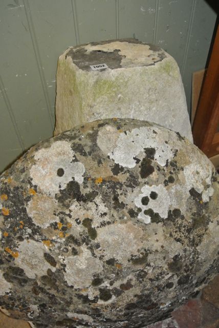 A weathered natural stone staddle stone and domed cap