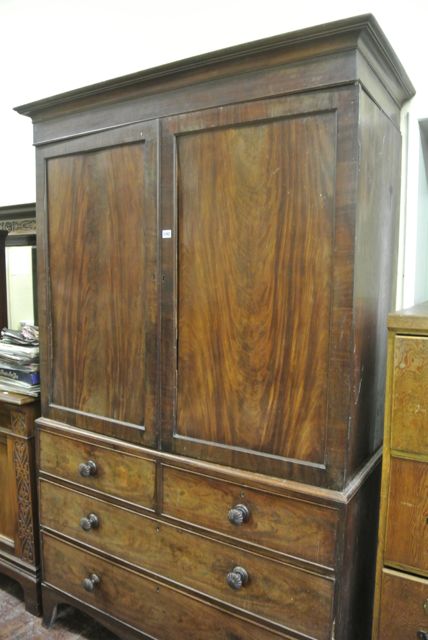 An early Victorian mahogany linen press of two long and two short drawers, the upper section