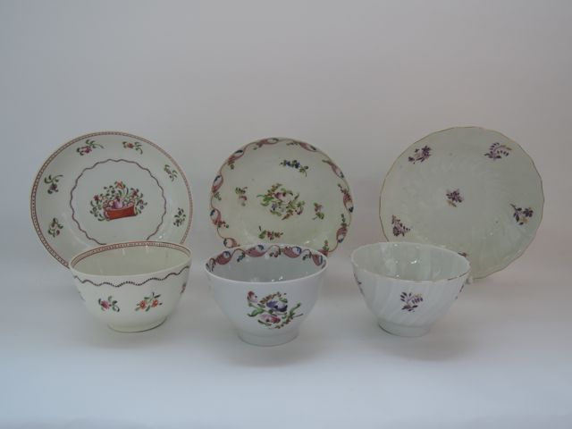 A collection of three late 18th and early 19th century tea bowls and saucers with various painted