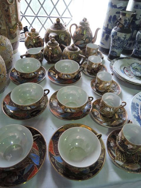A collection of Japanese eggshell porcelain tea and coffee wares with painted and gilded character