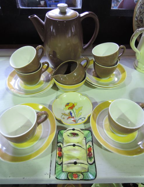 A Crown Ducal coffee set comprising coffee pot, sugar bowl and cream jug, six cups and saucers in