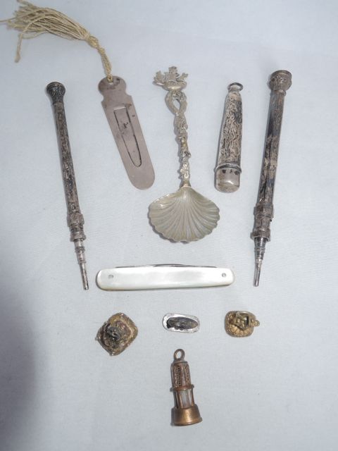 A silver book marker, silver and mother-of-pearl fruit knife, two 19th century fobs, two