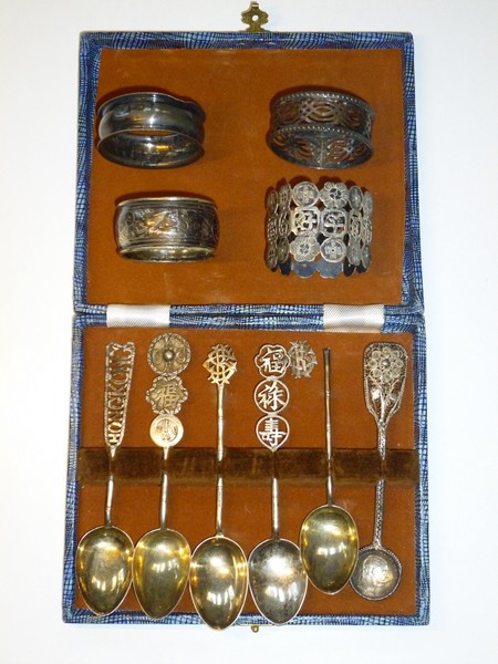 FOUR NAPKIN RINGS (TWO SILVER, TWO WHITE METAL) AND SIX WHITE METAL SPOONS (CASED)
