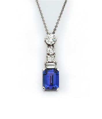 A TANZANITE AND DIAMOND PENDANT NECKLACE en suite to previous lot, the pendant claw set with an