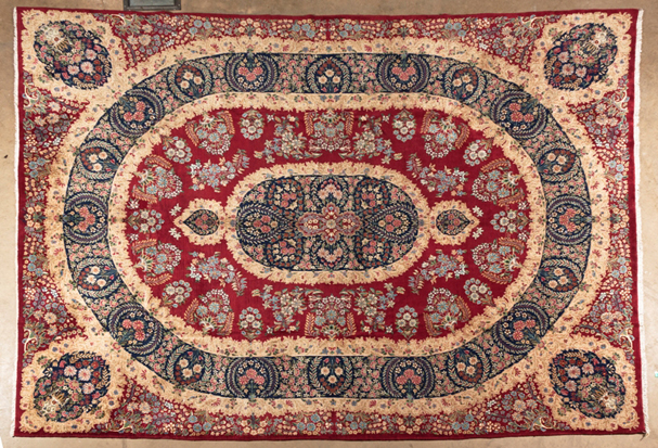 A KIRMAN CARPET, SOUTH EAST PERSIA, MODERN the red field with a circular slate-blue floral