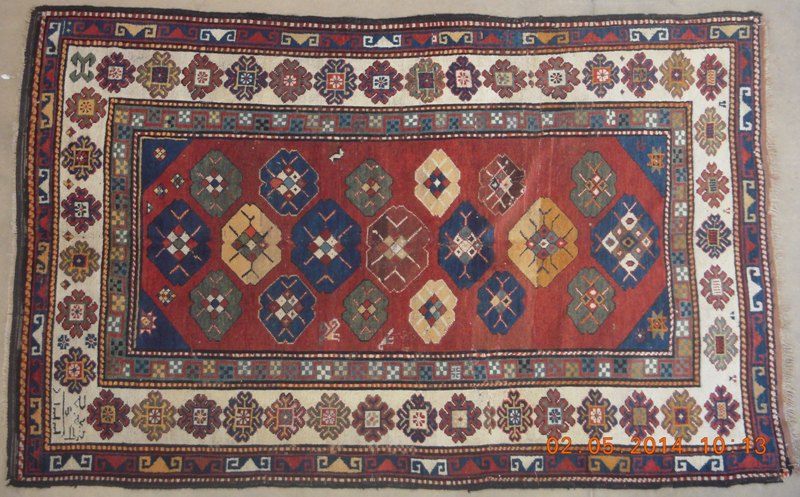 A KAZAK RUG, SOUTH EAST CAUCASUS, CIRCA 1900 the brilliant red field with an overall arrangement of
