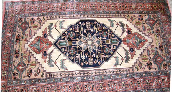 A Khorossan Silk Rug, Persia, modern the ivory field with a dark blue floral diamond medallion and