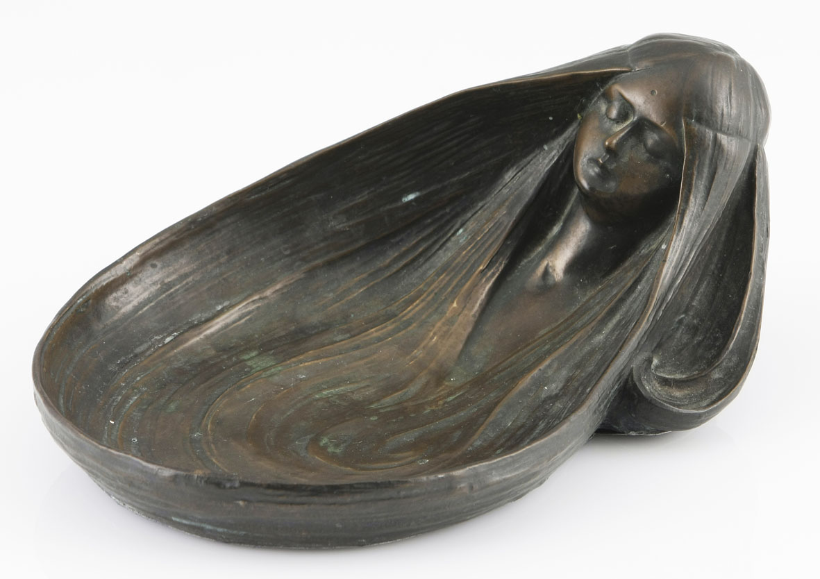 An Art Nouveau patinated bronze `Vide-Poche` cast from a model by Gurschner, of oval form, modelled