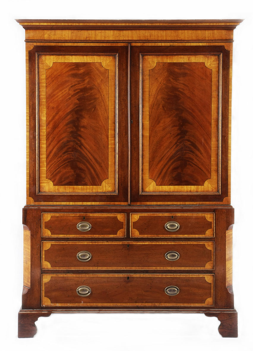A William IV mahogany and satinwood linen press, first half 19th century the outset pediment above