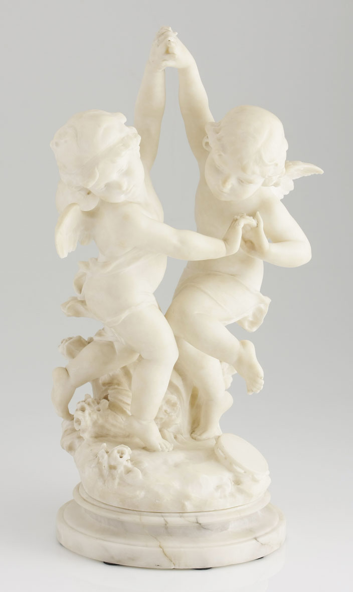 A Continental carved white marble figural group modelled as two winged cherubs dancing, on a