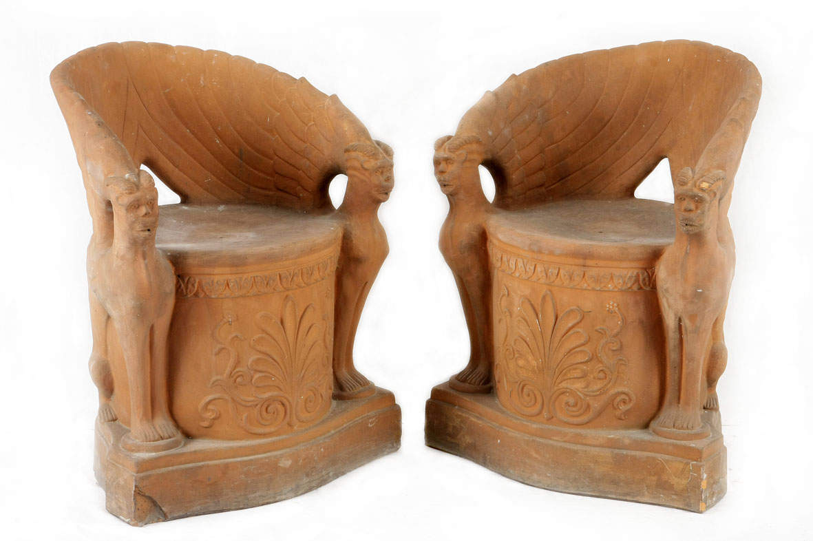 A pair of Victorian terracotta garden chairs, 19th century each moulded with stylised sphinx side