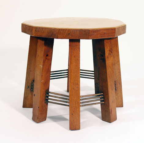 An Arts and crafts elm topped stool on eight supports joined by copper stretchers   CONDITION