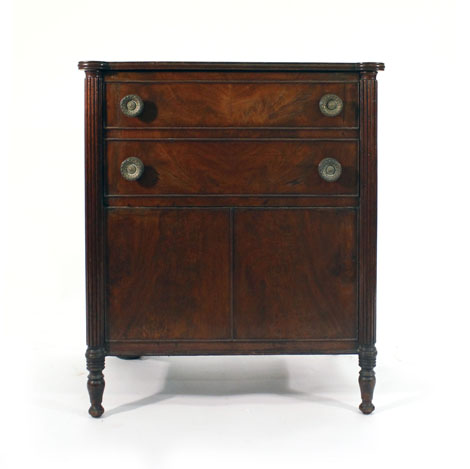 A Regency mahogany lift-top commode with projecting reeding stiles on turned feet, w. 63 cm