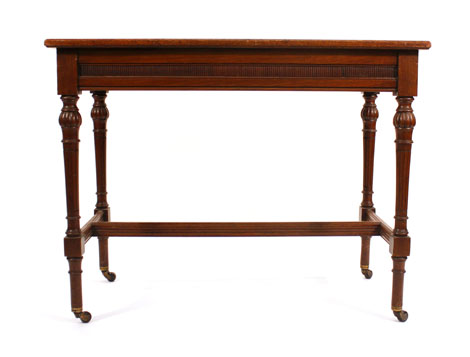 An Edwardian walnut side table with moulded frieze on turned and fluted legs, w. 90 cm