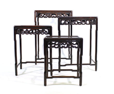 A set of late 19th century Chinese rosewood quartetto tables with panelled tops and open friezes