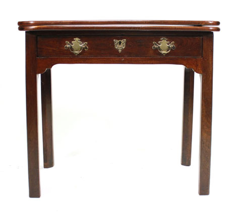 An 18th century mahogany card table of 'D' shaped outline with fold over top and frieze drawer on