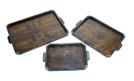 A graduated set of three Art Deco walnut and strung trays, max w. 67 cm
