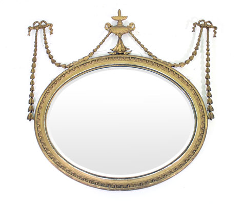 An Adam-style wall mirror, the oval plate in a swagged moulded gilt frame, w. 86 cm    CONDITION