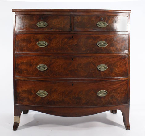 A Regency mahogany bow fronted chest of three graduated long and two short drawers on swept