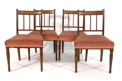 A set of four Regency mahogany dining chairs with square railed backs and upholstered seats on