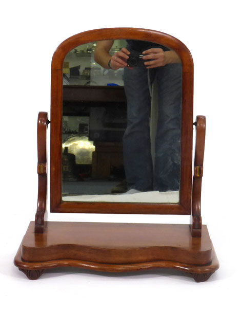 A Victorian mahogany toilet mirror with arched rectangular plate on a serpentine base, w. 47 cm