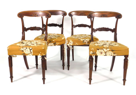 A set of four William IV rosewood and brass mounted dining chairs with moulded frames on lotus