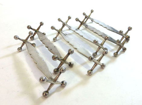 A set of six 19th century Hungarian metalware knife rests, the terminals in the form of jacks,