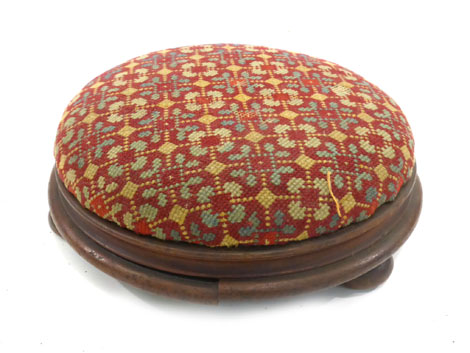 A Victorian walnut footstool with needlework top on bun feet, d. 29 cm